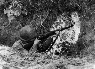 An U.S.  soldier shoots on Vire front in France (summer 1944)