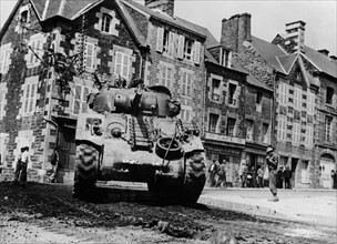 A U.S.  tank moves up to front in Brehal (France) Summer 1944