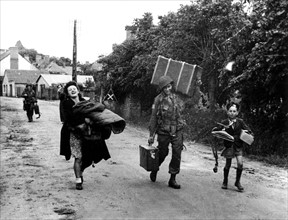 U.S. soldier helps French girl somewhere in Normandy, June 1944