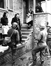 Alsatian women welcome  U.S. troops in Gundershoffen, March 17, 1945