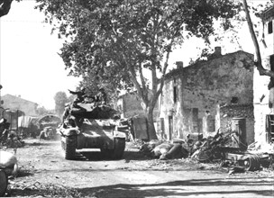 A 7th Allied Army tank passes debris in Southern France, August 1944
