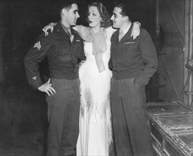 Marlene Dietrich with two American soldiers in Paris, 1946
