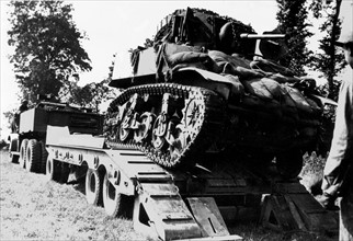 Damaged U.S. tank bound for repair shop in France, summer 1944