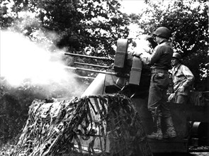 American anti-aircraft gun support U.S. infantry advance  in Normandy, summer 1944