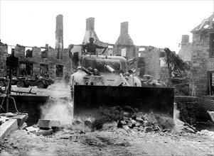 American bulldozer tank levels the way  in Lonlay l'Abbaye,  August 1944