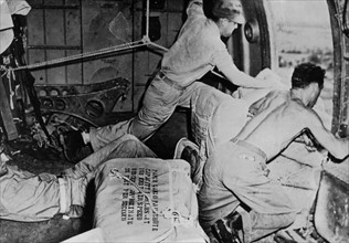 Paper parachutes drop supplies for Burma front, 1944