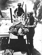 American medical officer examines a German prisoner in Italy, May 18, 1944
