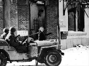 Belgian  girl directs U.S. troops toward fleeing Germans, January 1945