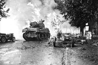 American troops enter through smoke of battle into Dreux,  August 18, 1944