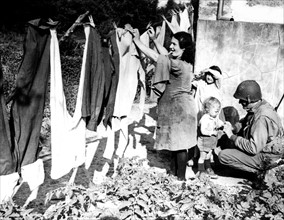 French woman washes U.S. soldiers' clothes near St. Lo, July 1944