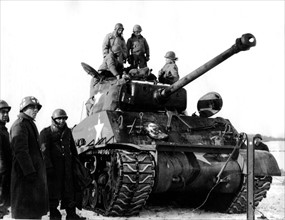 A new  tank (M-36) of the 4th U.S. Division is inspected by three U.S. pilots, January 1945