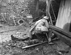 A Medic with the 1st U.S. Army tends a wounded soldier in Germany, December 10, 1944
