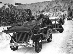 American medical men evacuate wounded in jeep in Belgium, January 1945