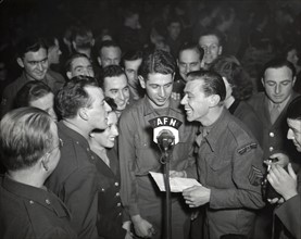 An American corporal is interviewed by a member of the American Forces Network  (March 10, 1945)