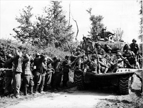 Prisonniers allemands et char allié sur la route de Sainte-Mère-Eglise