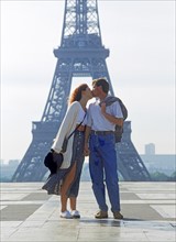 Couple kissing at Palais de Chaillot in Paris with Eiffel Tower