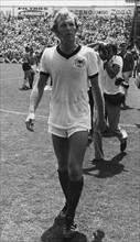 English defender and team captain Bobby Moore wears the tricot of the German soccer team and walks