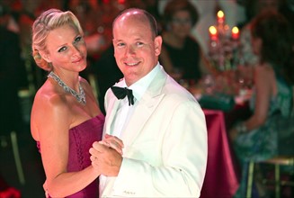 Prince Albert II of Monaco and his wife, Princess Charlene of Monaco, dance at the 63rd Red Cross