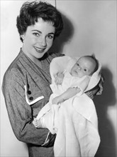 3/6/53 Actress Elizabeth Taylor holds h