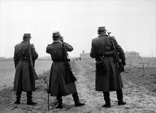 GDR People's Police men observe American sector in Berlin