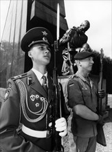 German and Russian soldier in front of Soviet monument in Berlin