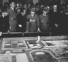 Adolf Hitler regards modell of Volkswagen factory