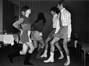 A group of young models, male and female, present themselves in mini skirts on 6 December 1966 in