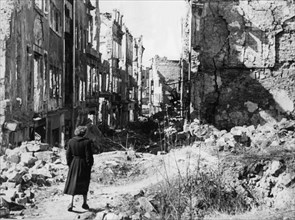 (FILE) An undated historical archive photo shows a woman walking in ruins in Dresden, Germany,