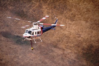 Photo taken on Dec. 20, 2019 shows a helicopter working at Lexton bush fire site in western Victoria, Australia
