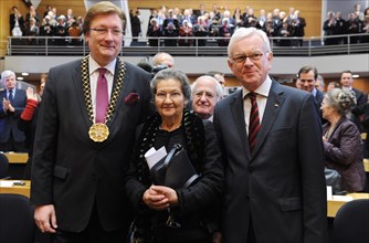 French politician Simone Veil (C) poses for a photograph with her husband Antoine (R) and Dirk