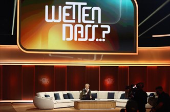 Thomas Gottschalk sits on the show's famous sofa at the beginning of the anniversary show "Wetten,