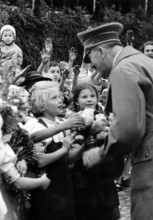The image from the Nazi Propaganda! shows Adolf Hitler as he is greeted enthusiastically by the