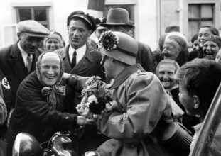 The Nazi propaganda picture shows the reception of German troops by Sudeten men and women in