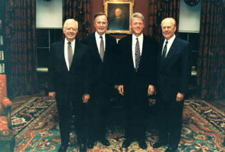 United States President Bill Clinton, center right, poses for a group photo with former US