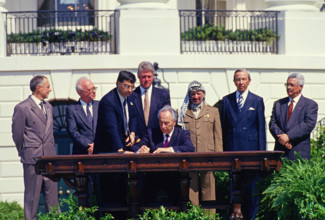 Minister of Foreign Affairs of Israel Shimon Peres puts his signature on the agreement during the