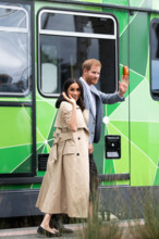 Britain's Prince Harry (R), Duke of Sussex and his wife Meghan, Duchess of Sussex, greet people during their visit to Australia in Melbourne, Oct. 18, 2018.