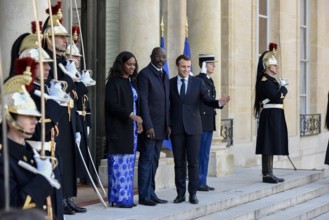 French President Emmanuel Macron and the newly elected visiting Leberian President George Weah pose for photos at Elysee Palace in Paris, France on Feb. 21, 2018.