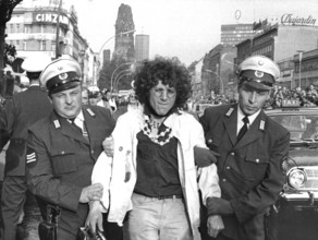 The Communard Rainer Langhans is taken away by two police officers after his arrest