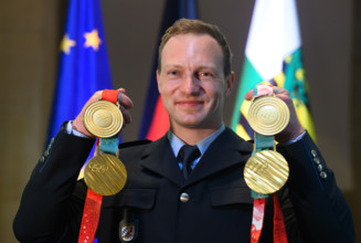 Francesco Friedrich, four-time Olympic bobsleigh champion, presents his gold medals from Beijing