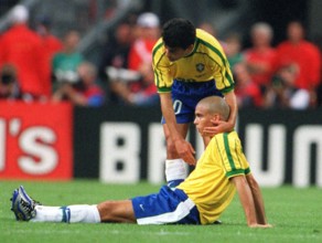 Brazilian forward Bebeto (standing) comforts his teammate Ronaldo after the 1998 World Cup final