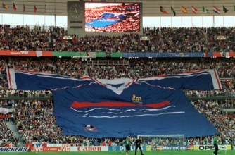 French supporters unfold a giant French national team jersey which spans across the stands just