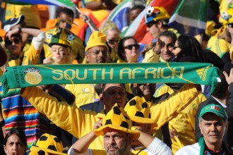 Fans celebrate during the opening ceremony of the 2010 FIFA World Cup at Soccer City stadium in