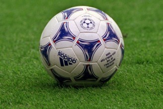 The official ball for the 16th soccer world cup lies on the pitch in the stadium in Lens, France,