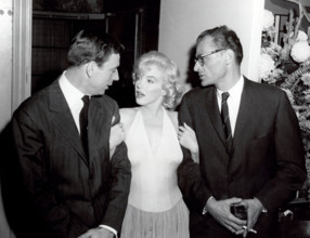 A happy trio at the Monroe cocktail party left to right Yves Montand, Marilyn Monroe and her