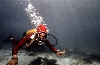 Farah Pahlavi diving during her holidays on Kish island, 1975