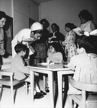 Farah Pahlavi visiting a school in Tehran. 1969