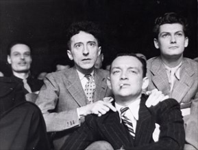 Cocteau and Jean Marais surrounding Roland Toutain, 1939