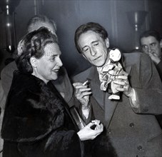 Jean Cocteau showing the puppet of the Emperor of China, 1949