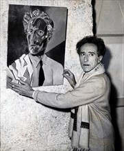 Cocteau accroche ses toiles pour une exposition à Nice, 1953