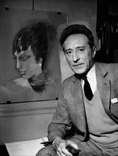 Cocteau sitting next to a pastel of Matisse's latest model, 1955